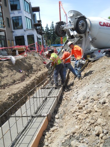 Construction workers pour concrete at the Trailside apartment homes at Emerald Heights.