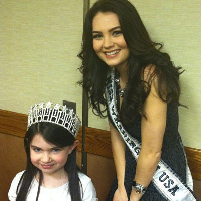 Cassandra Searles shares her Miss Washington USA crown with a Junior Achievement student.
