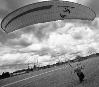 Sergy Chepurko works with the wind as he practices paragliding techniques in a field at Marymoor Park last week.