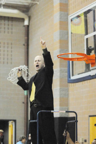 The Bear Creek boys basketball coach Scott Moe cuts down the net after the Grizzlies won the tri-district championship in March and earned the program’s first berth to the state tournament.
