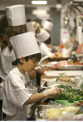 Anthony Krichevskiy preps ingredients for the Breakfast Omelet he made during the Lake Washington School District Kids Can Cook Culinary Competition at Redmond Junior High last Wednesday.