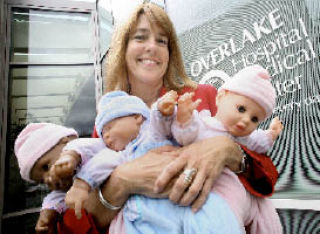 Education coordinator Susan Higley holds baby dolls that are used in the Overlake Hospital Medical Center’s Super Sitters babysitting class.
