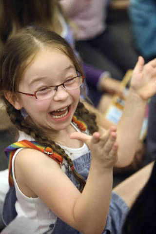 Faith Morrison doesn’t hold back her excitement during Junie B. Jones’ performance at Borders Books last Wednesday. Morrison was one of several hundred kids on hand at the Junie B. Jones Stupid Smelly Bus Tour show.