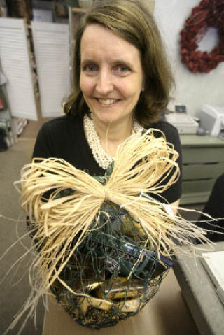 Susan Huenefeld of Accents Et Cetera holds up an eco-friendly gift basket at her business
