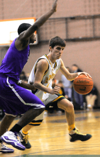 Redmond guard Will Ellis charges around Garfield’s Des’Juan Newton during second quarter action of Friday’s home game against Garfield. The game was called with 5:26 to go in the fourth quarter.  KATHERINE GANTER  Redmond Reporter