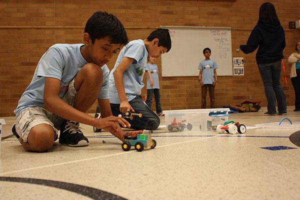 Alcott Elementary fifth-grader Sid Vijay makes adjustments on his car while preparing for the upcoming Destination Imagination Global Finals competition next week.
