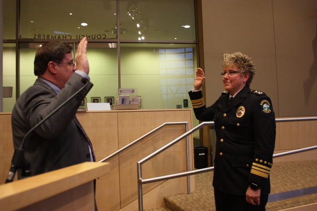Former Assistant Police Chief Kristi Wilson gets sworn in by City of Redmond attorney James Haney as the new police chief of the Redmond Police Department on Tuesday night at the City Council meeting. Samantha Pak