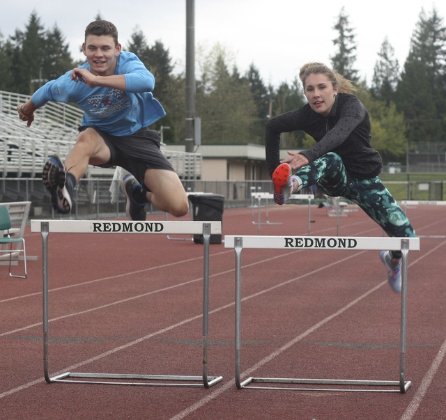 Redmond High’s Steve Brown and Claire Johnson fly high in practice on Tuesday afternoon. Andy Nystrom
