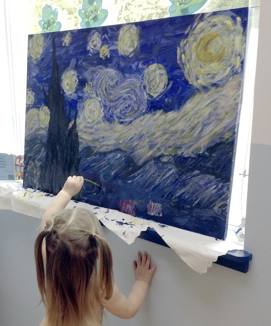 A Goddard School student puts the finishing touches on her class’s rendition of Vincent van Gogh’s “The Starry Night.” Courtesy photo