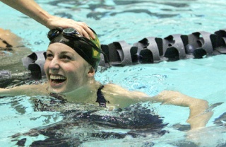 Redmond sophomore Heather Harper is all smiles after seeing that she tied for first place in the 100-yard breaststroke final at Saturday’s Class 4A state swim/dive championships at the King County Aquatic Center in Federal Way. The Mustangs placed third as a team