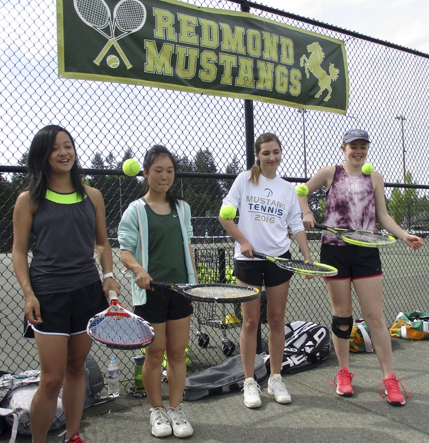 Redmond High tennis players have a ball before Tuesday’s practice. They are