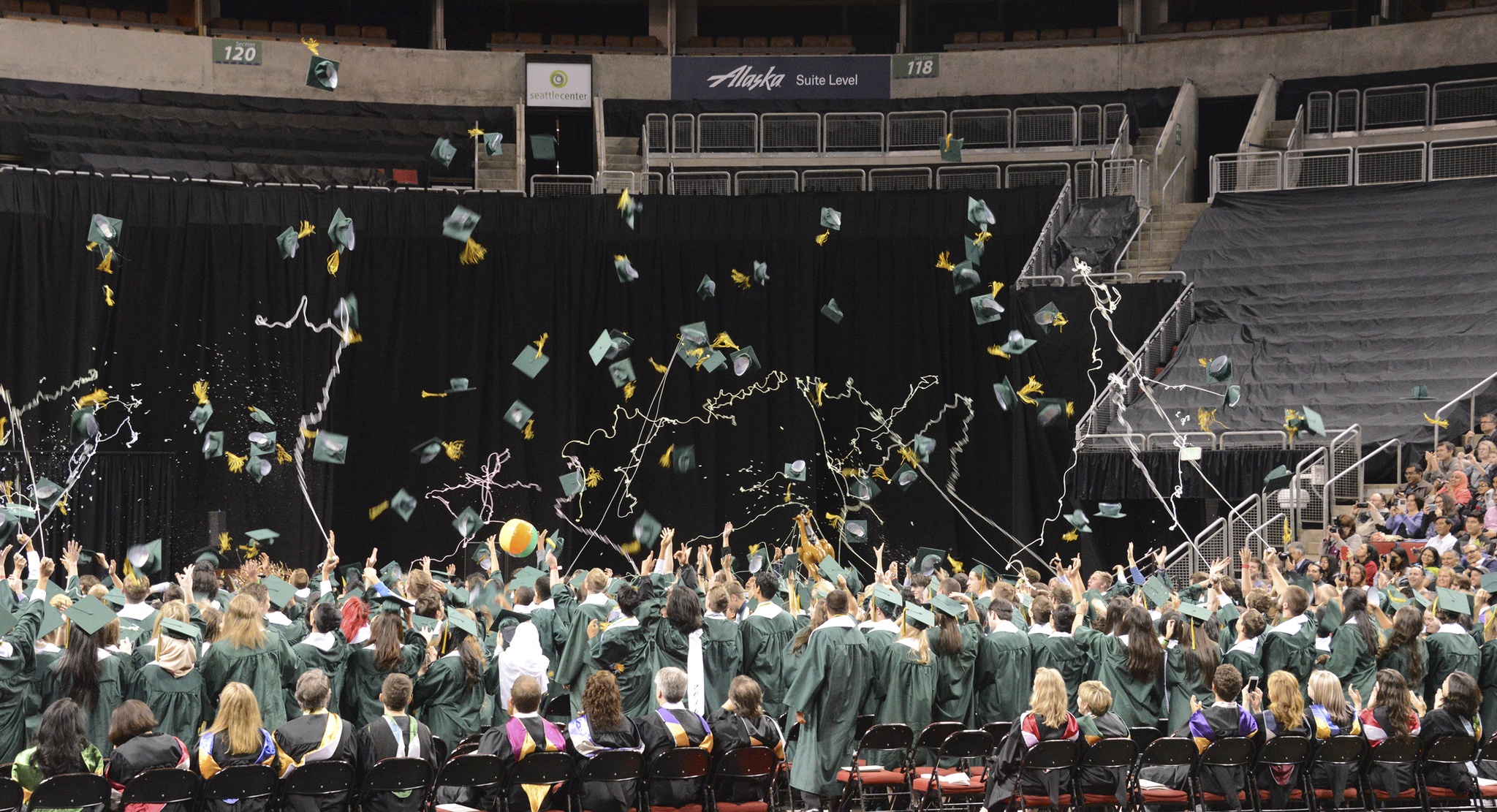 Redmond High graduates toss their caps at the close of the Mustangs’ commencement. Andy Nystrom