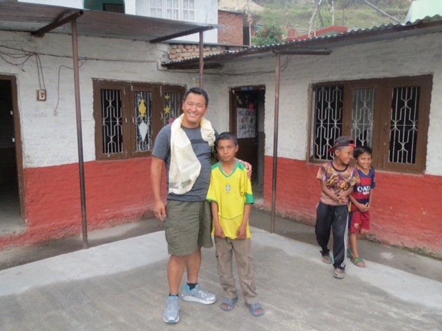 Danu Sherpa visits with a child in Nepal during his recent trip back to his homeland. He is a City of Redmond employee. Courtesy photo