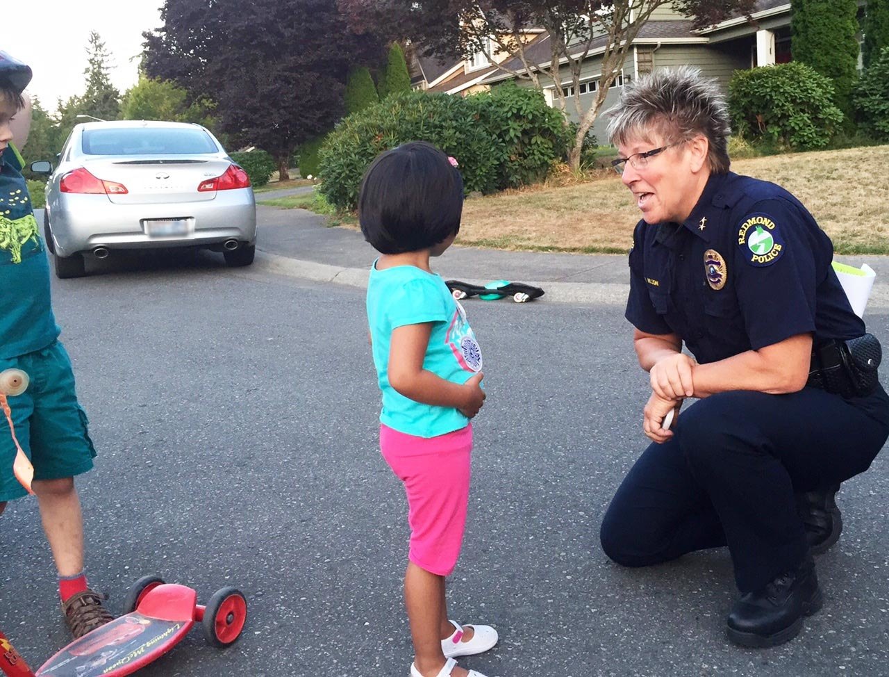 Redmond Police Chief Kristi Wilson speaks with a resident at one of last year’s National Night Out Against Crime events. Courtesy photo