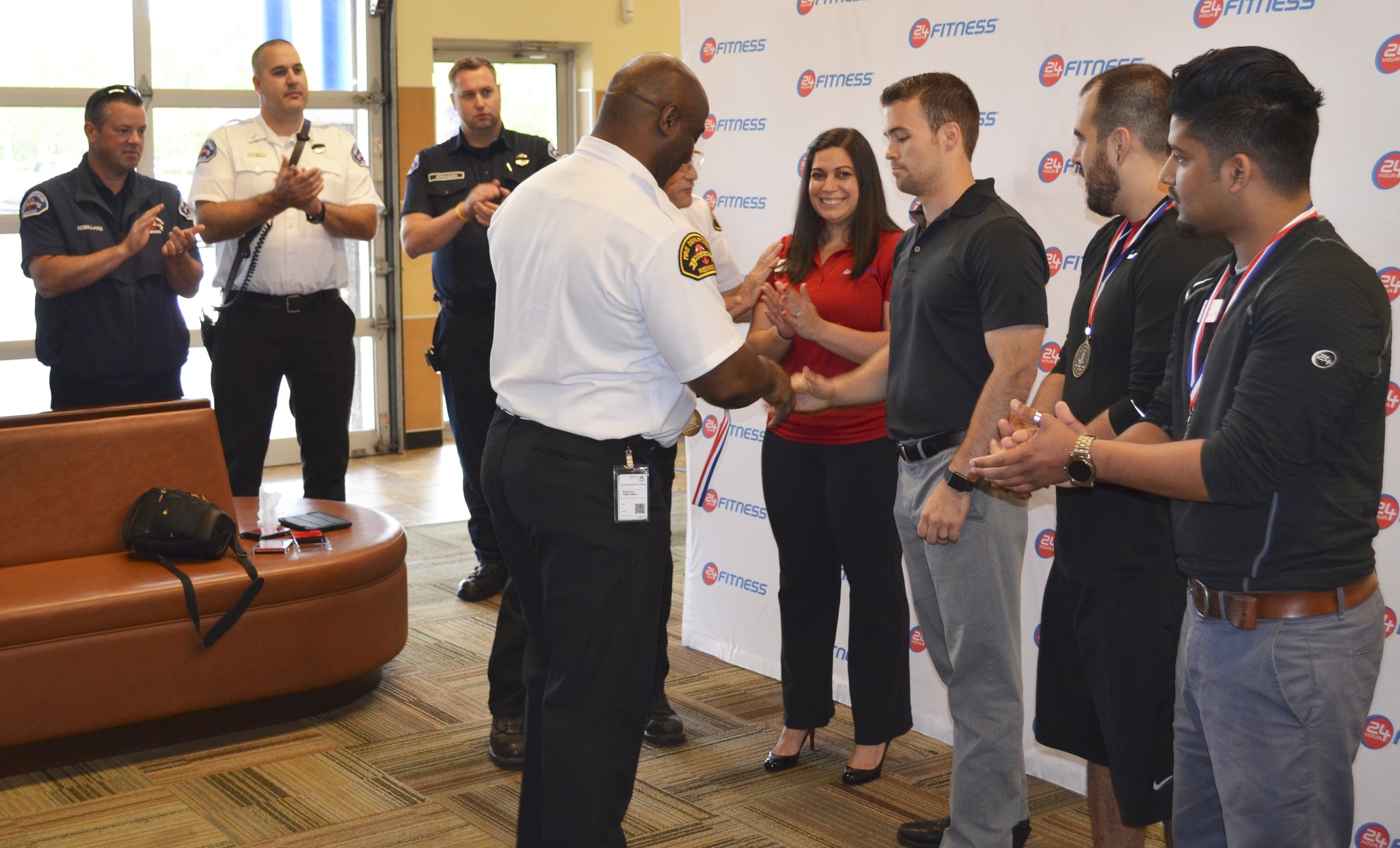 Redmond Fire Department chief Tommy Smith honors 24 Hour Fitness’s Laurel Moffitt