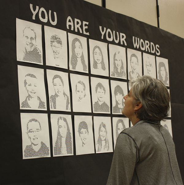 Sunrise Elementary School assistant Jayleen Ryberg checks out the sixth-graders’ artwork on Tuesday night at the school’s fifth annual art night. The school’s Rachel’s Challenge Through the Arts Program focuses on showing compassion for others. In the photo