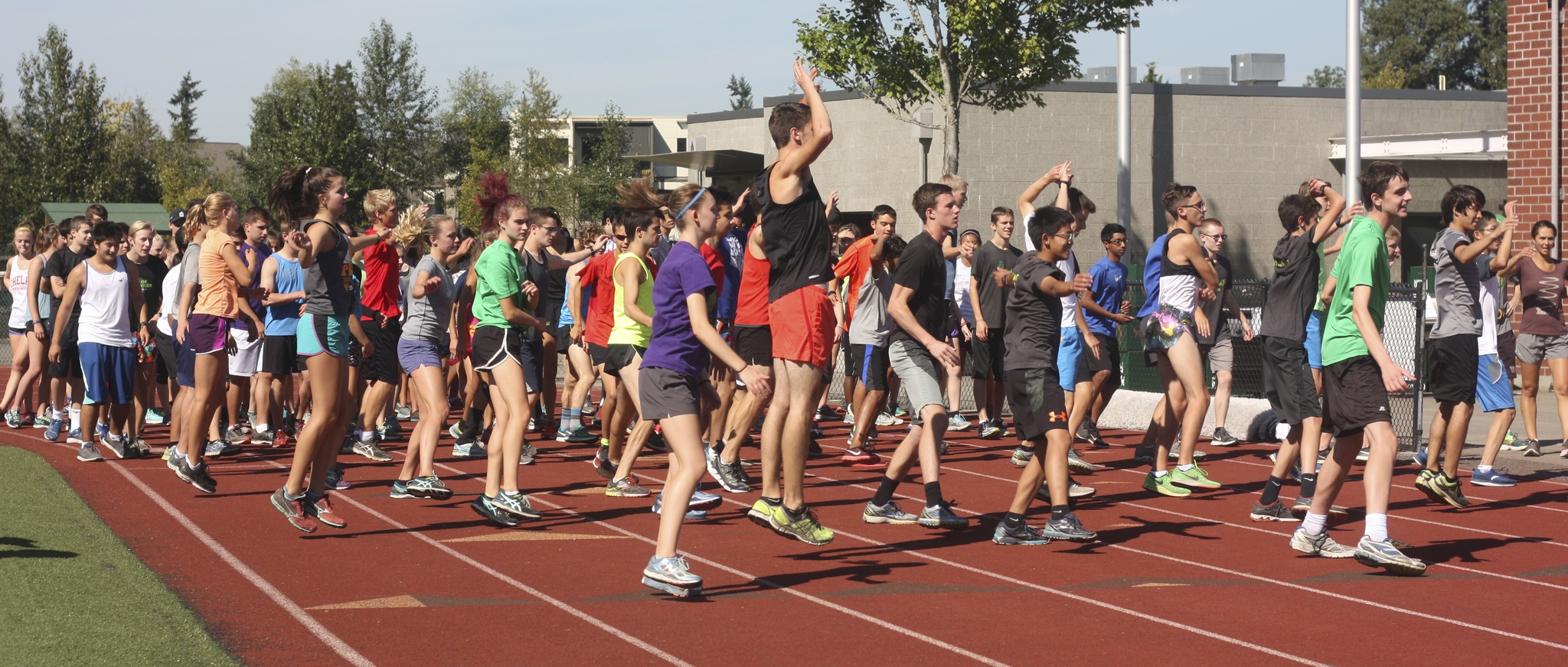 Redmond High’s cross country teams begin their training session on Monday afternoon on the school track. Andy Nystrom