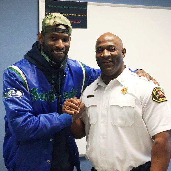 Ricardo Lockette visits with Redmond Fire Chief Tommy Smith on March 4.