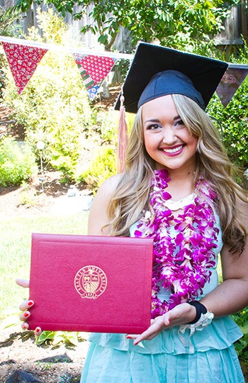 Cassandra Hargin-Muller proudly displays the diploma she received after graduating from Seattle University’s College of Nursing this month.