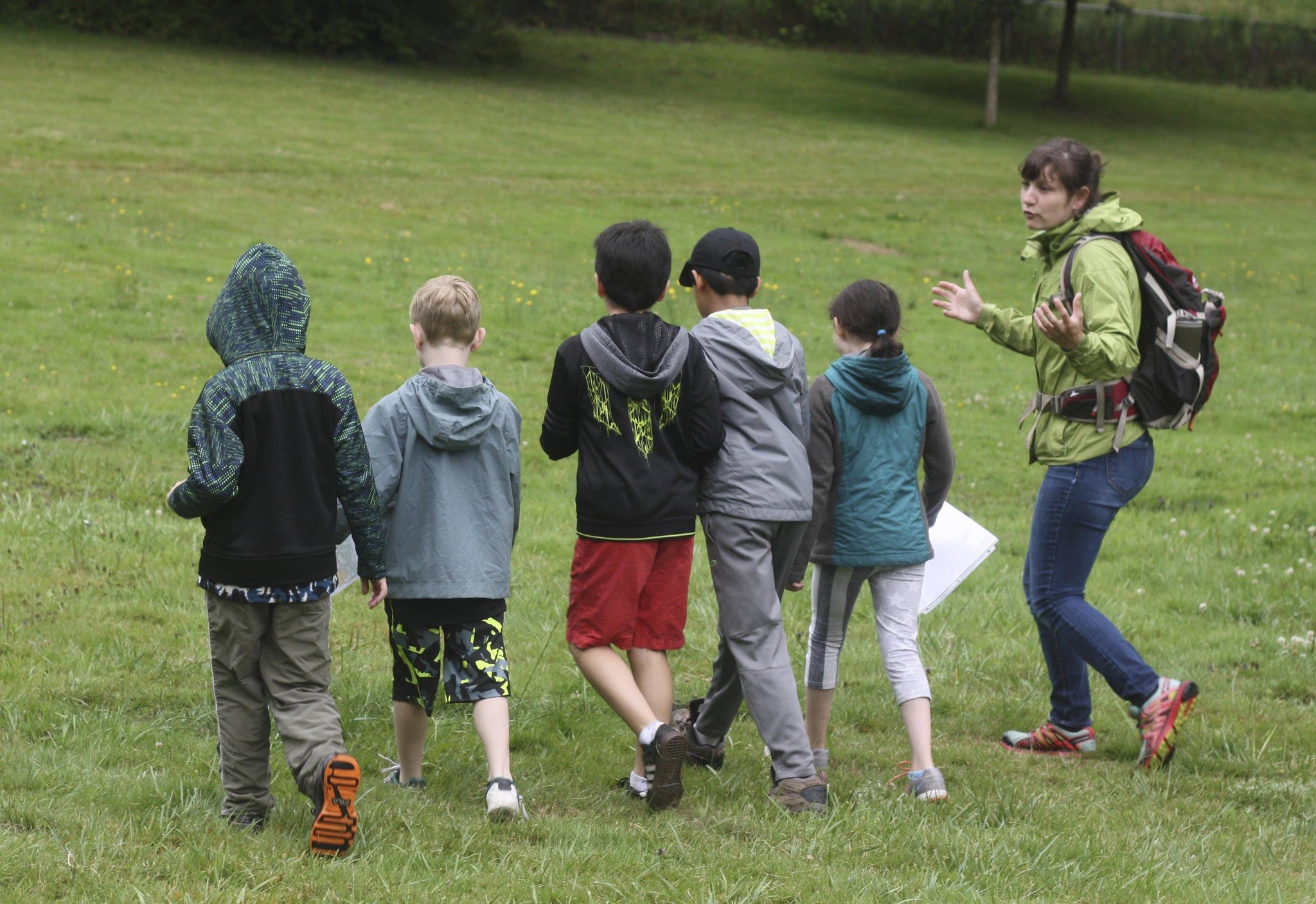 Leader Becky Pittman keeps track of her campers at Farrel-McWhirter Park in Redmond during a Nature Vision Outdoor Skills Camp in July. The kids focused on compass and mapping work.