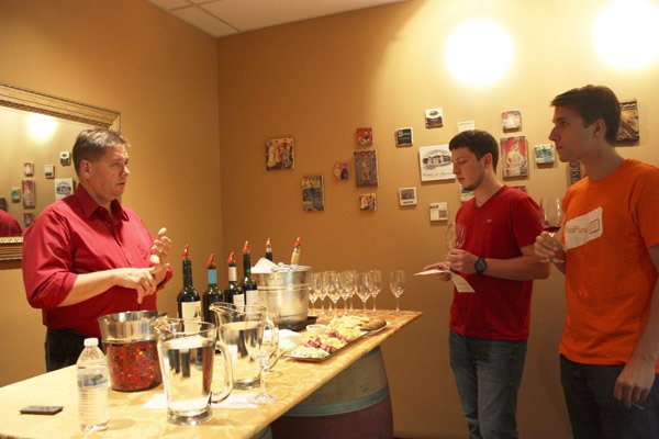 Steve Body (left) shares his knowledge on Argentine wines with Ryan Billing (center) and Tony Mandarano at one of LetsPour's weekly wine tastings in Redmond.