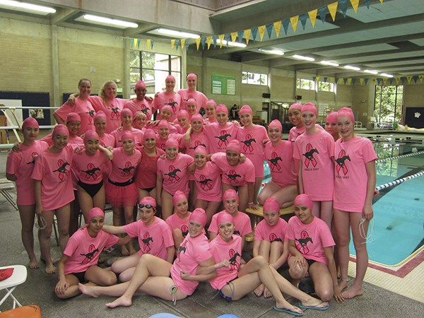 Redmond High’s swim and dive team sports pink shirts and caps to support breast cancer awareness month at its Oct. 17 meet versus Eastlake High at Redmond Pool.