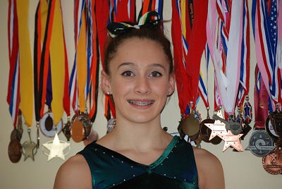 Redmond High’s Sierra Mukerjee is surrounded by some of her championship medals.