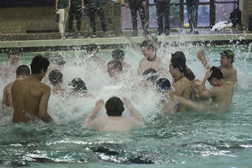 Redmond High’s boys swimmers get fired up before Tuesday’s home meet with Eastlake High.