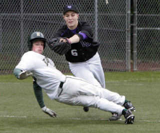 Lake Washington’s Blake Lively (No. 6) chases Redmond’s Tim Wilson down between second and third base during the game at Hartman Park.  Wilson was out on the play