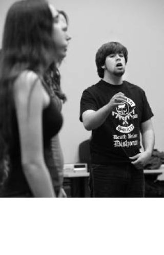 Student director Jack Terrill sings with other choir members during a short rehearsal for “Night on Broadway” at Redmond High School.