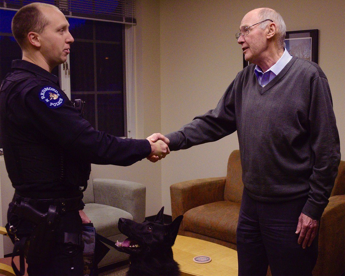 Issaquah mayor Fred Butler honors Redmond police officer Dan Smith and K9 Remy on Wednesday at Issaquah City Hall for working with Issaquah police to arrest a burglary suspect in early January. The male suspect broke into a house, the resident saw him and the suspect fled. Smith and Remy combed through several back yards and found the man hiding in a blackberry bush. Courtesy photo