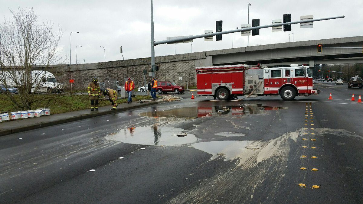 Redmond firefighters survey the scene where 40-50 gallons of roofing glue spilled on a portion of Redmond Way this morning. Courtesy of the Redmond Police Department