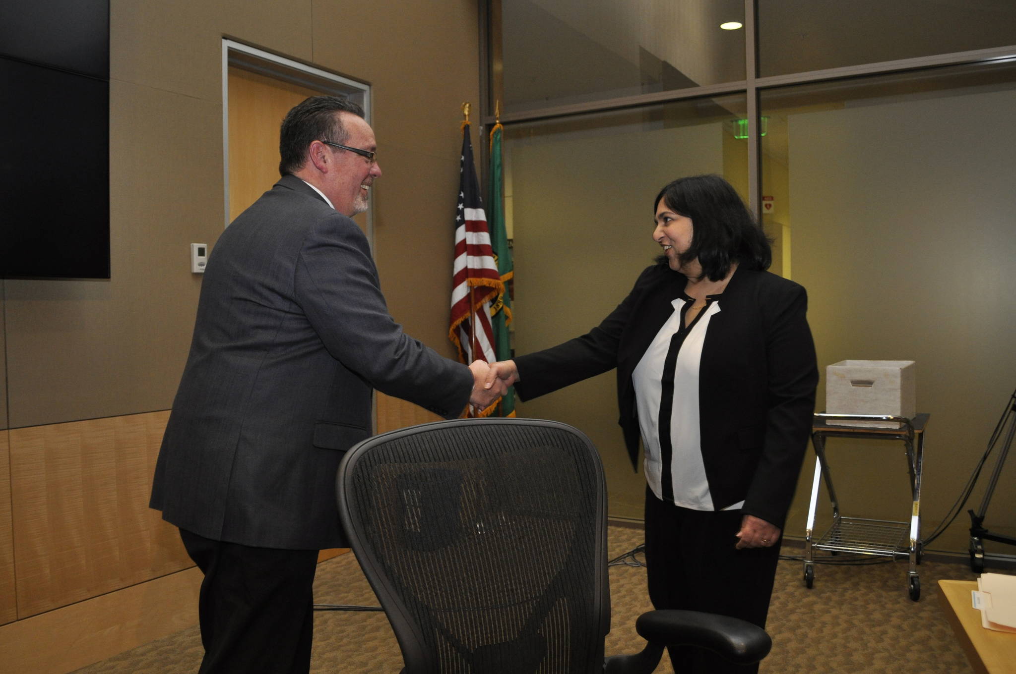 Redmond City Council president Hank Margeson (left) congratulates newly appointed council member Tanika Padhye after her appointment Tuesday evening. Courtesy of Chip Cornwell, City of Redmond.