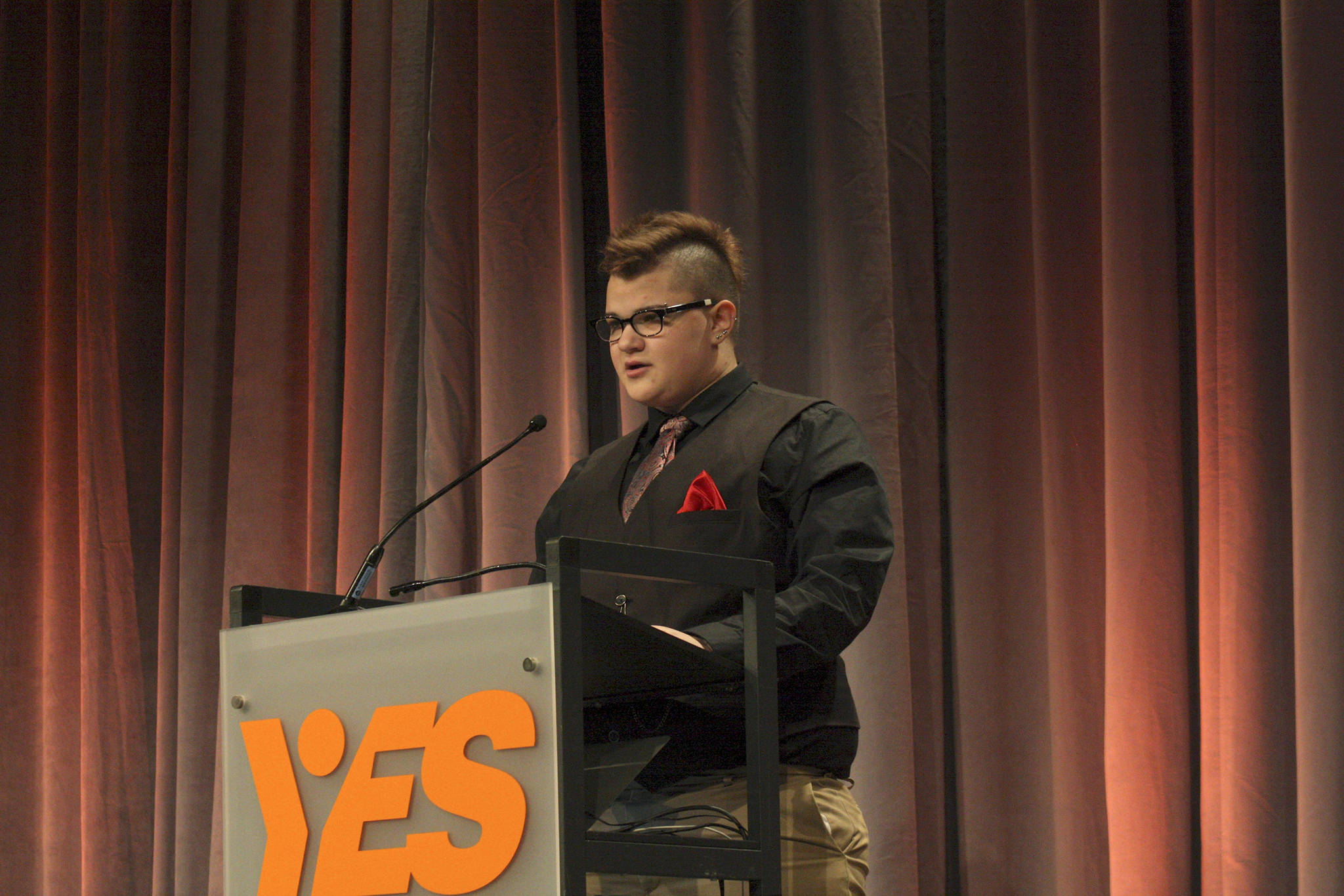 Redmond teen Mason Bernardo speaks about his challenges struggling with gender identity, self-harm and abusive relationships at the Youth Eastside Services breakfast on Wednesday morning. Bernardo, who was born female, has begun transitioning to a male. He spoke of hurting himself in deep depression and anxiety, but has since received help from Youth Eastside Services. Ryan Murray/staff photo
