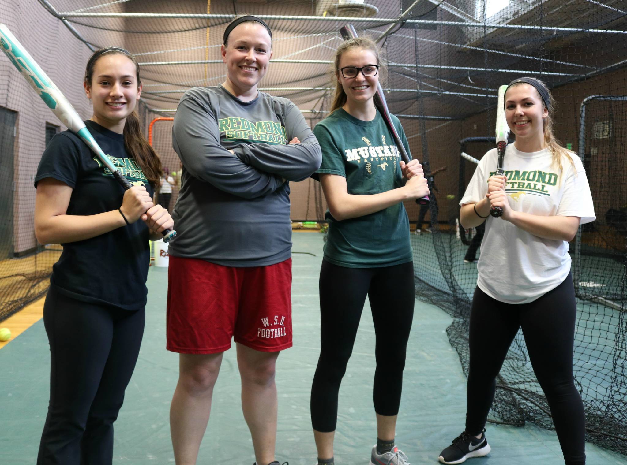 Redmond’s bats are ready for 3A KingCo play. From left, Keona Tibbs, head coach Alison Mitchell, Hannah Winner and Taylor Ray. Andy Nystrom, Redmond Reporter