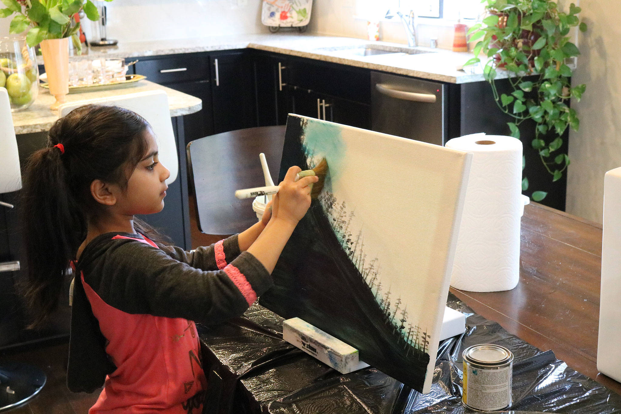 Ira Ganjikunta, 6, works on a painting at her Redmond home. CATHERINE KRUMMEY/Kirkland Reporter