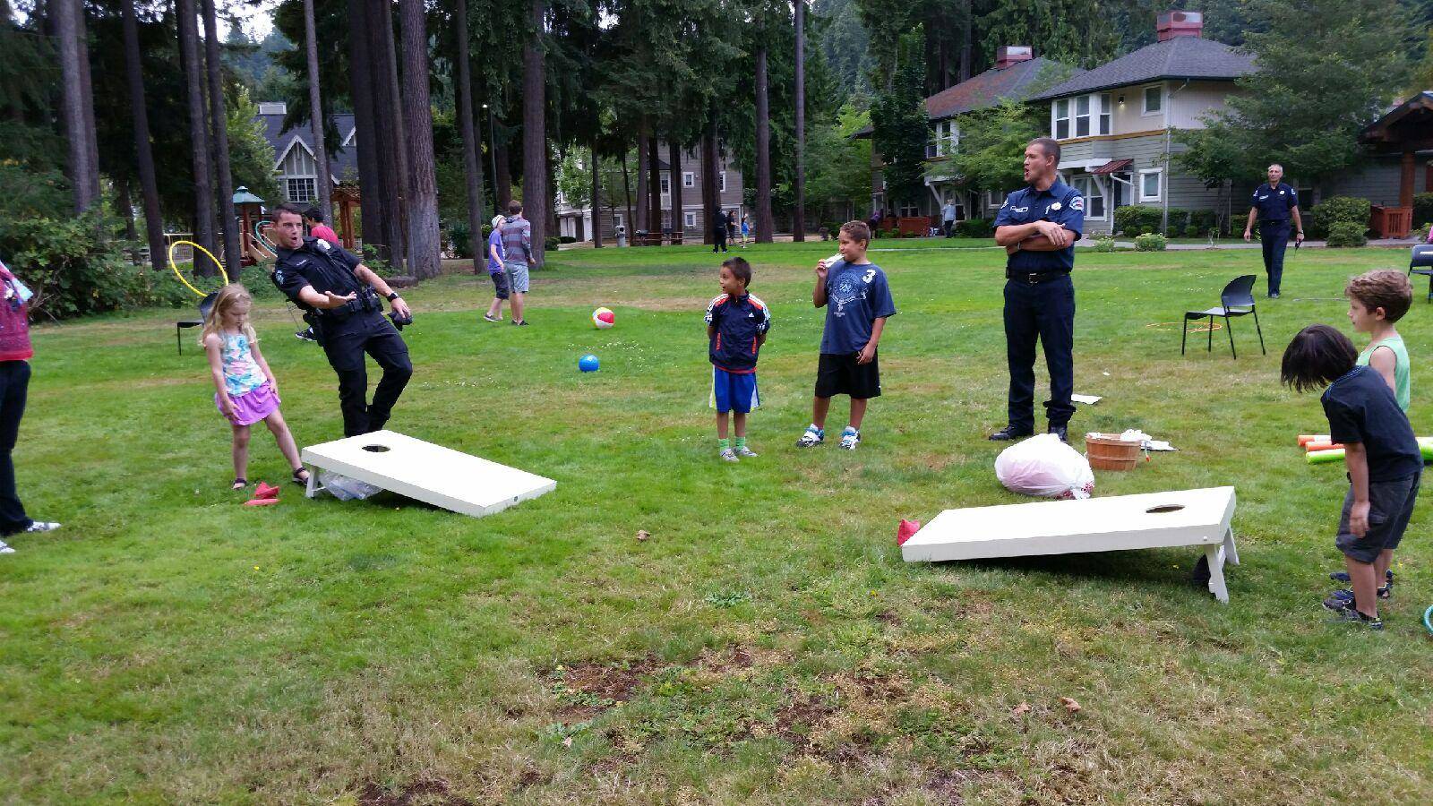 Redmond police officers play a game with residents at last year’s National Night Out. Courtesy photo