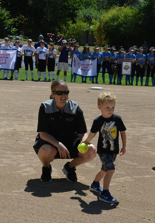 Pacific Lutheran University head softball coach and Redmond native Brandi Gordon-Bennett watches as her son Charlie, 4, throws out one of the first pitches at today’s Junior League Softball World Series opening ceremony at Everest Park in Kirkland. Gordon-Bennett is a Redmond High graduate and played boys baseball at Redmond North Little League until she was 16. At today’s ceremony, she addressed the teams, encouraging the players to do their best and have a good time. Andy Nystrom/Redmond Reporter