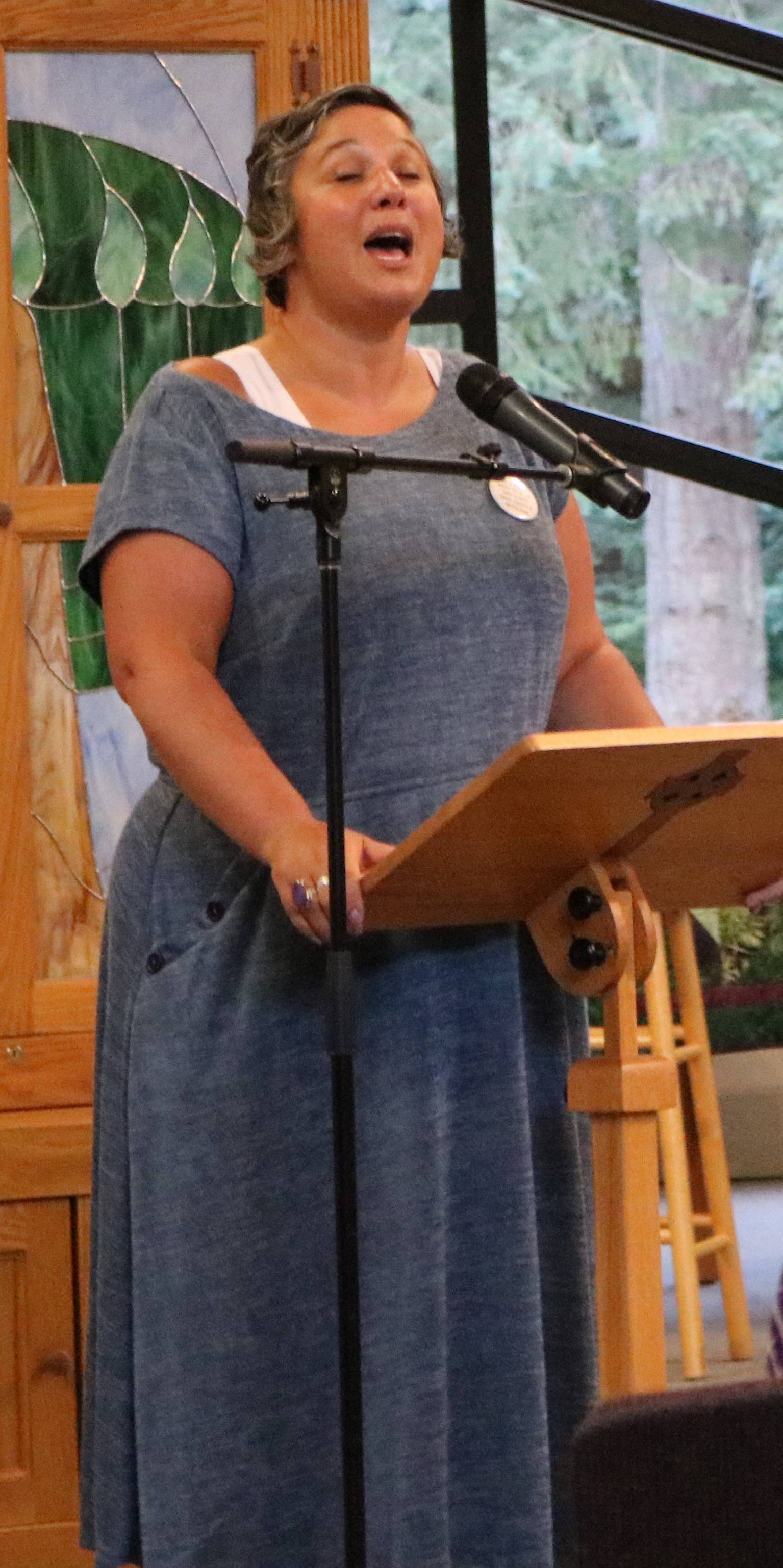 Rabbi Yohanna Kinberg leads vigil participants in song on Wednesday night at Congregation Kol Ami in Woodinville to remember Heather Heyer as well as offering calls for peace. The congregation serves the Redmond community. Aaron Kunkler/Redmond Reporter