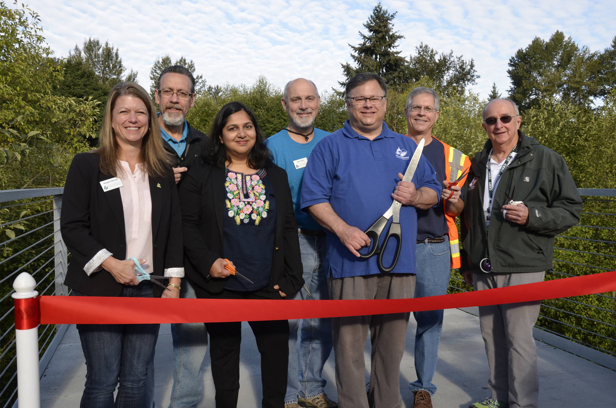 From left to right at the Redmond Central Connector Phase II opening: Redmond City Council members Angela Birney, Hank Margeson, Tanika Padhye, John Stilin, Mayor John Marchione, and city council members Byron Shutz and Hank Myers. Not pictured: City council member David Carson. At right, an artist’s rendering of a portion of the connector. Courtesy photo and graphic