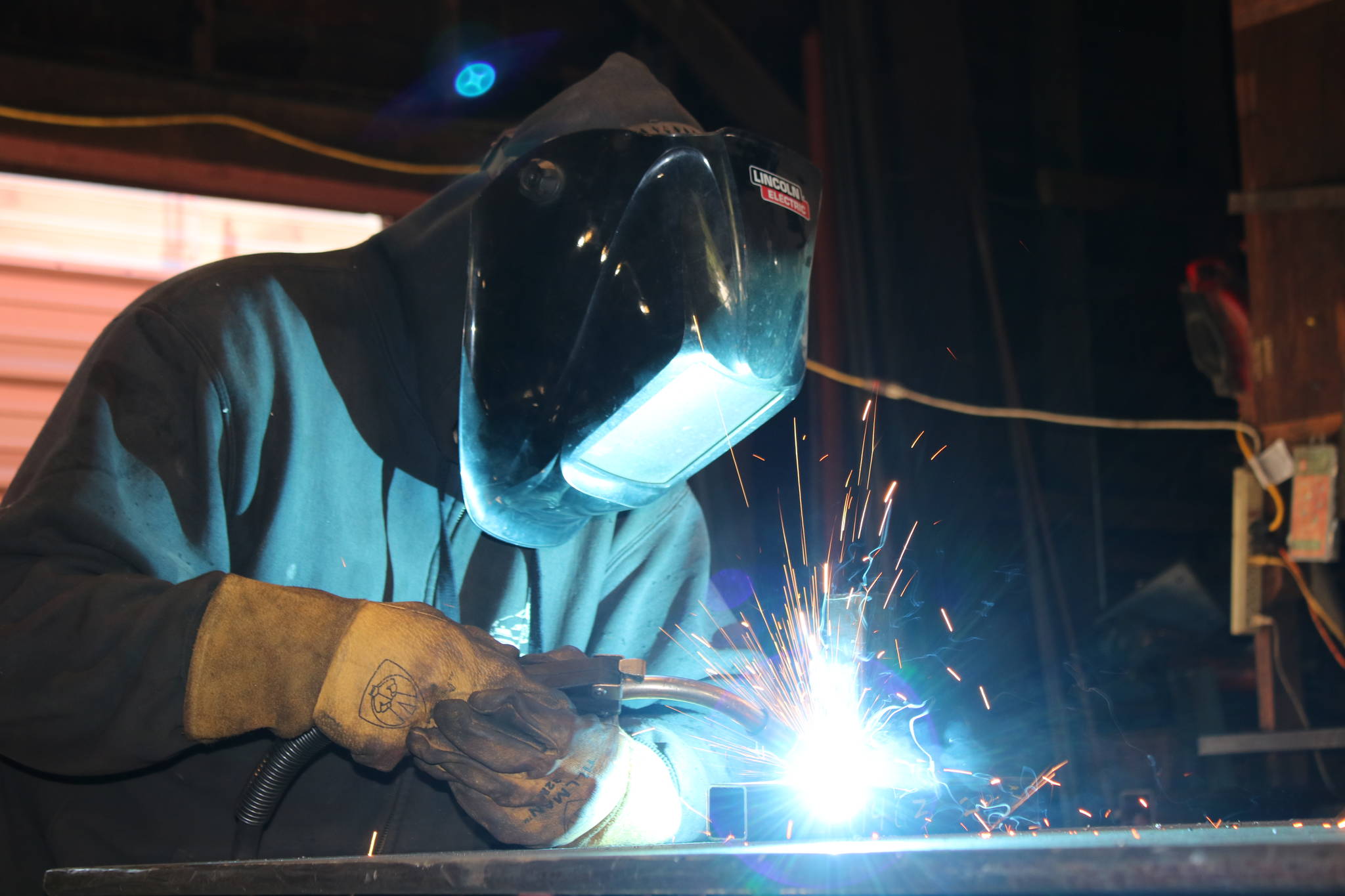 Morgan Scarboro welds at Ace Iron Works in Redmond. Aaron Kunkler/ Redmond Reporter
