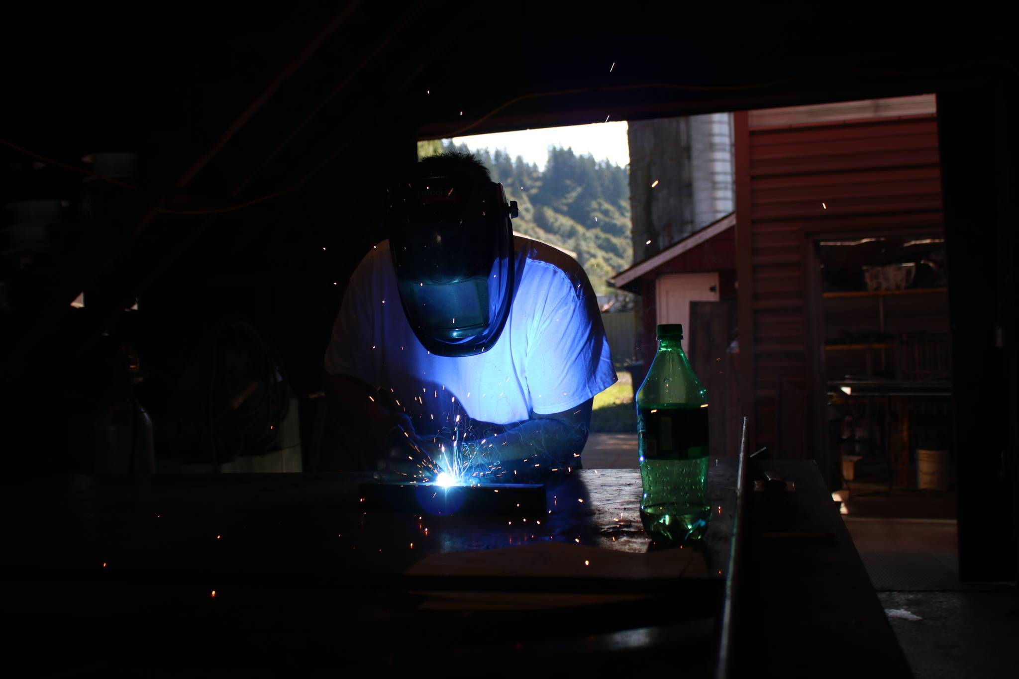 Jim Athan, owner of Ace Iron Works, welds in his shop. Aaron Kunkler/Redmond Reporter