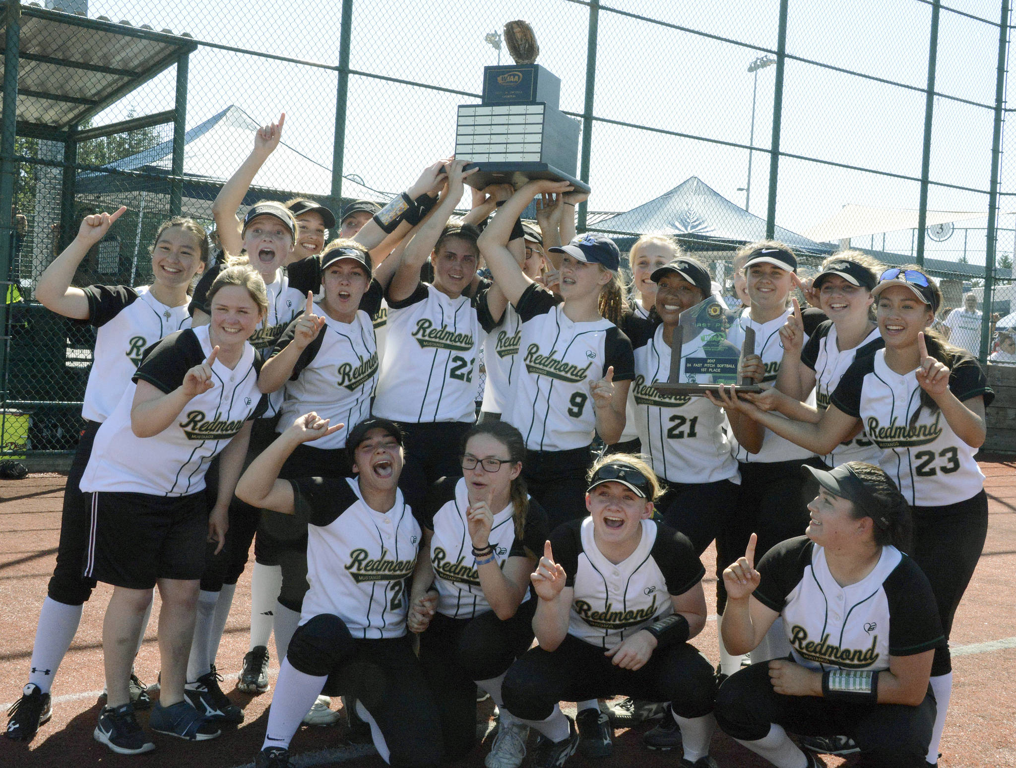 Redmond High’s softball team celebrates winning the 3A state title last year followingits 9-5 victory over Yelm at the Regional Athletic Complex in Lacey. Andy Nystrom/staff photo