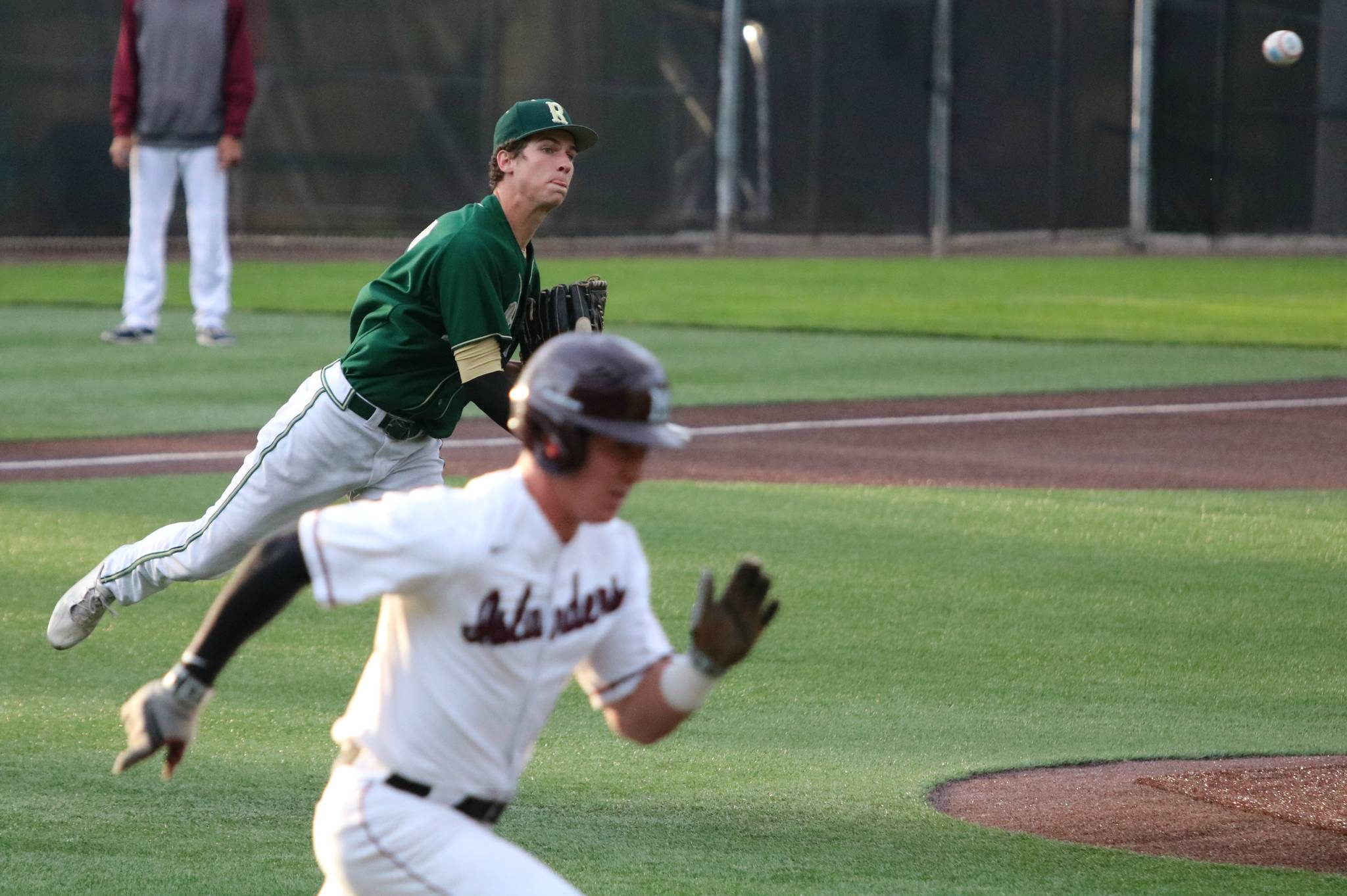 Redmond pitcher Connor Barison throws out a Mercer Island runner. Andy Nystrom / staff photo