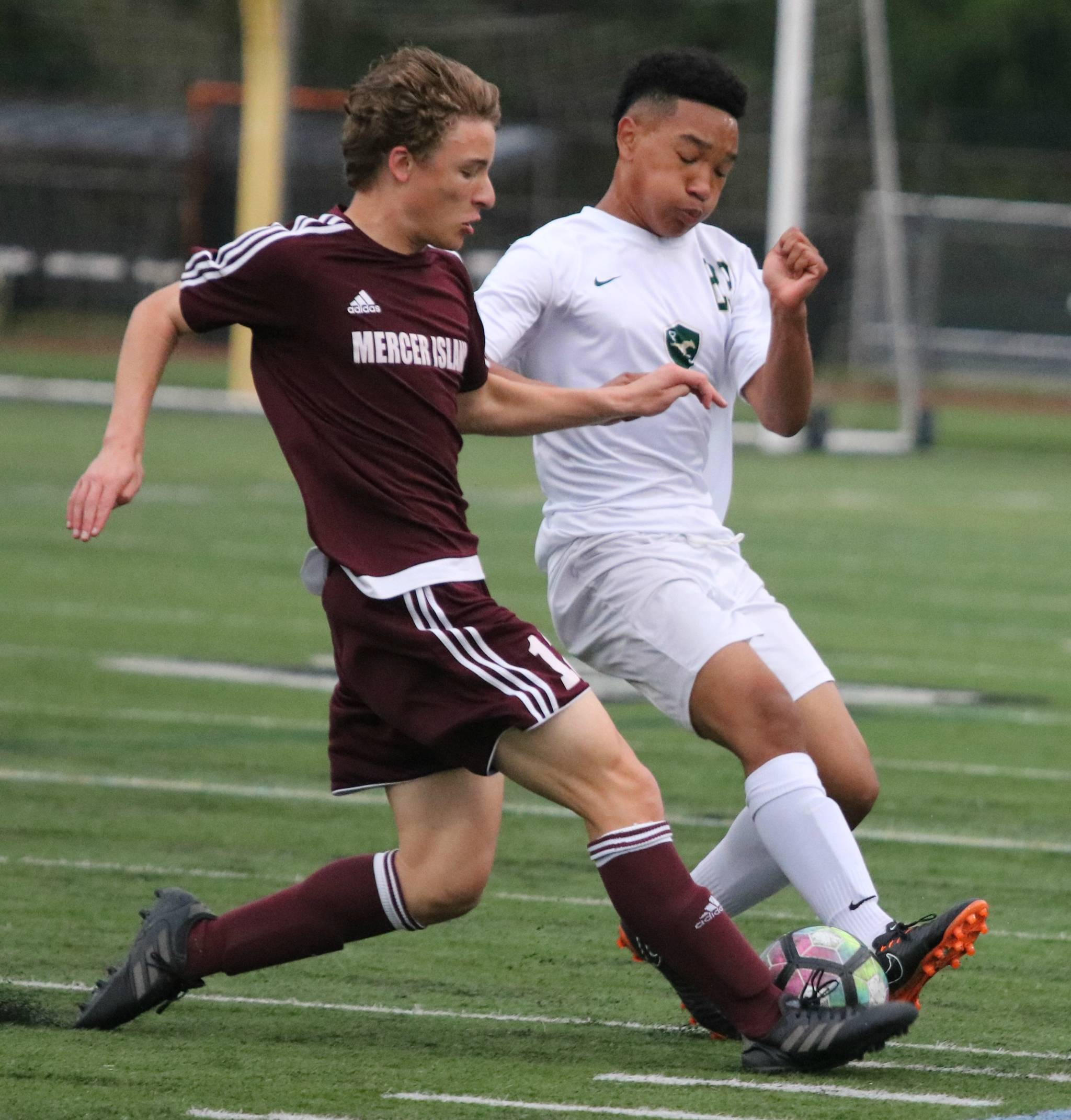 Redmond’s Martin Dadzie, right, battles with a Mercer Island player. Andy Nystrom / staff photo