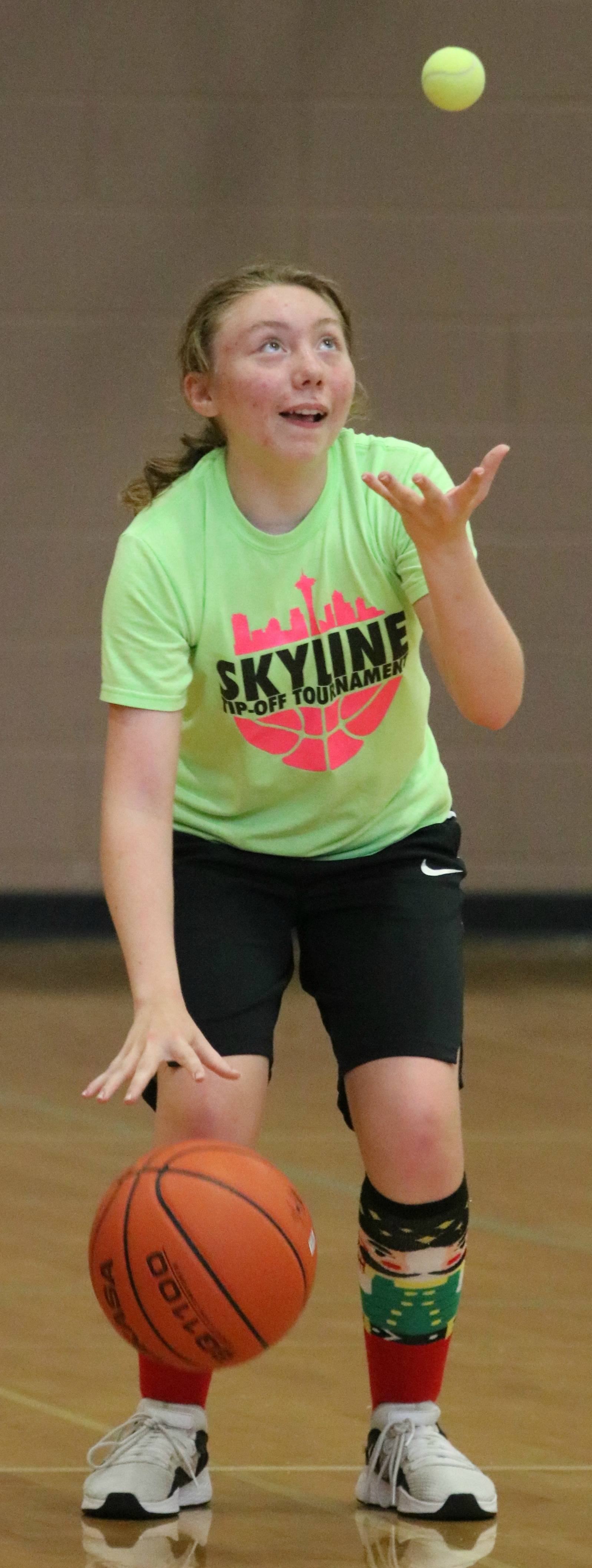 Emily Wren practices her dribbling skills while tossing a tennis ball at the Redmond High School Girls Basketball Summer Camp on June 26. Andy Nystrom / staff photo