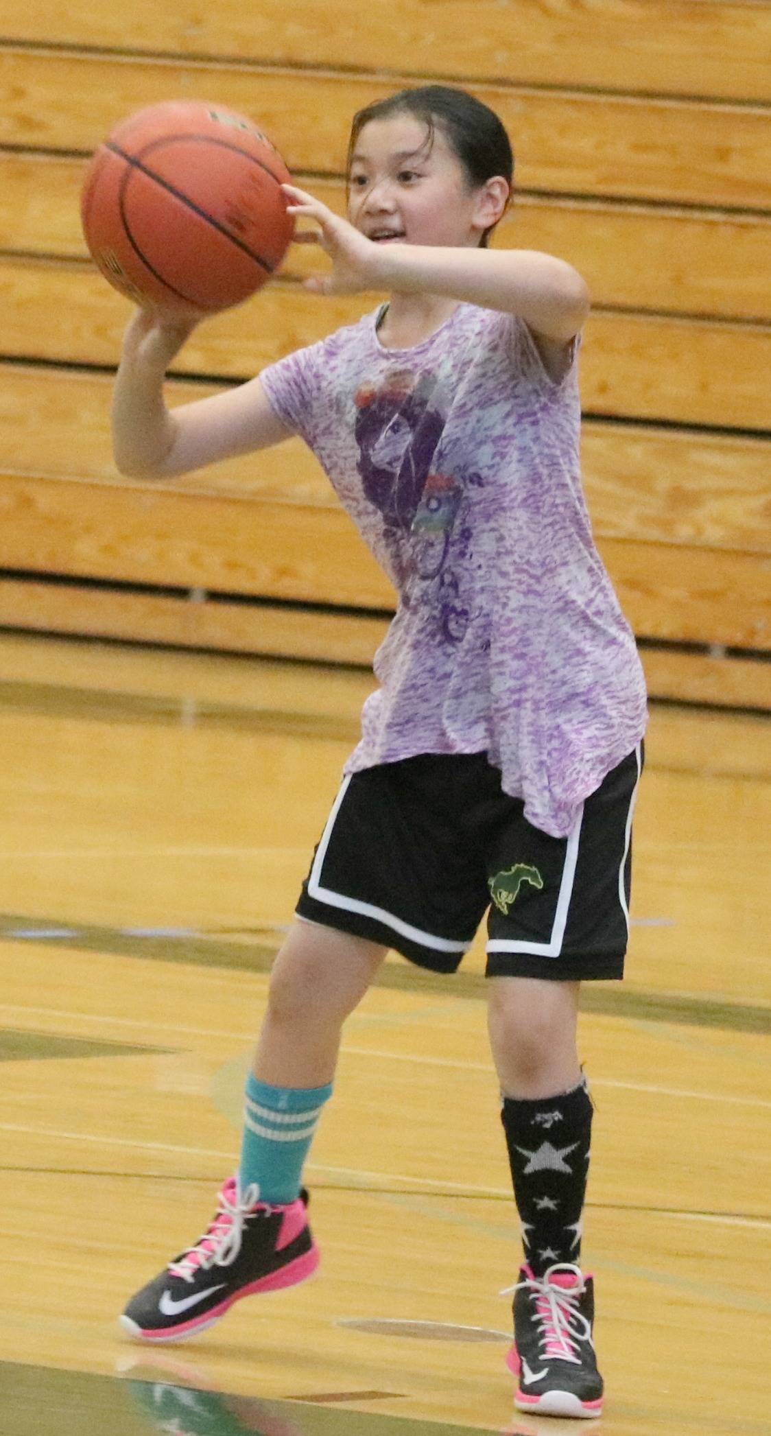 Riley Huang practices her passing skills at the girls hoops camp. Andy Nystrom / staff photo
