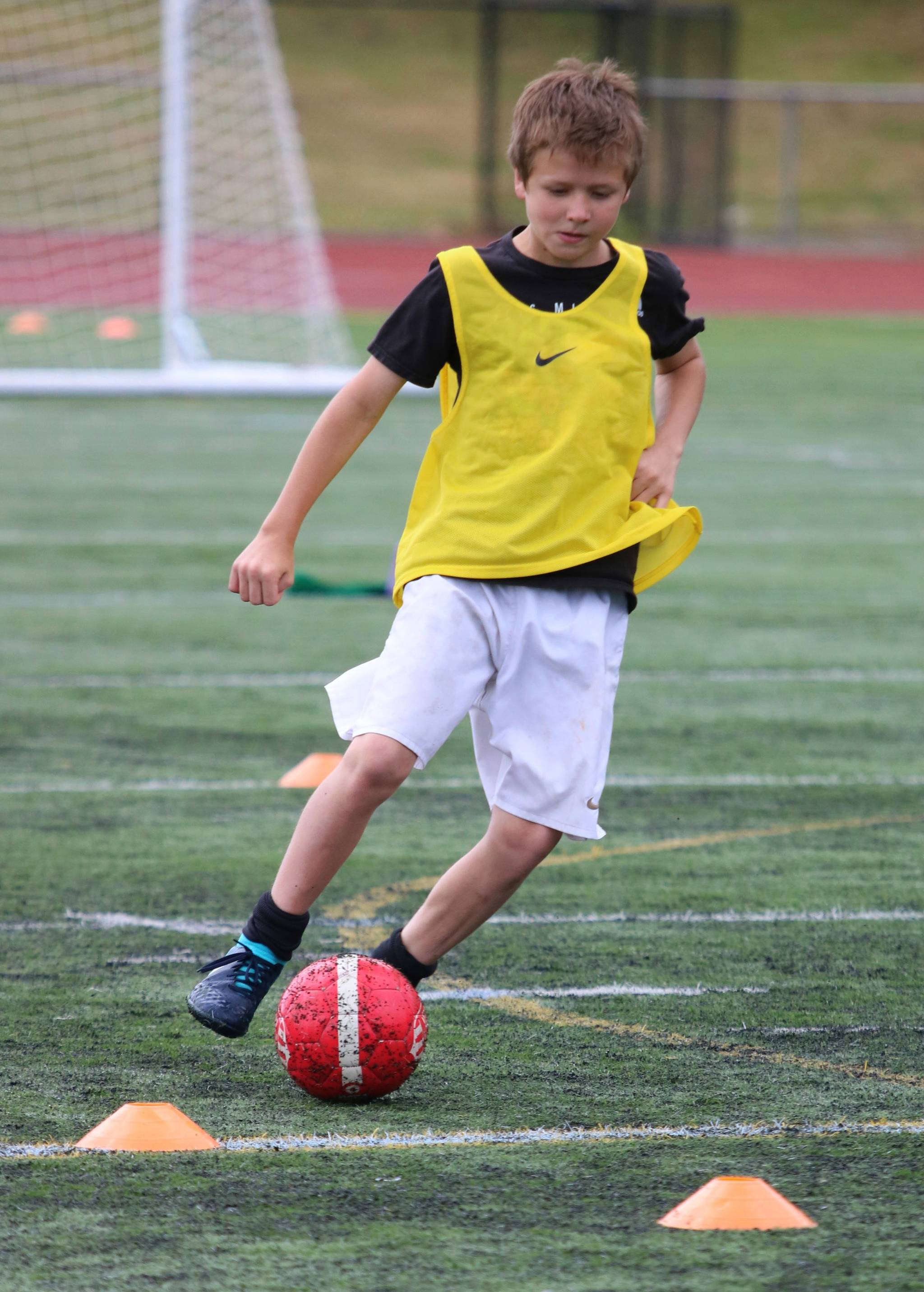 Liam Cain dribbles up field during the camp. Andy Nystrom / staff photo