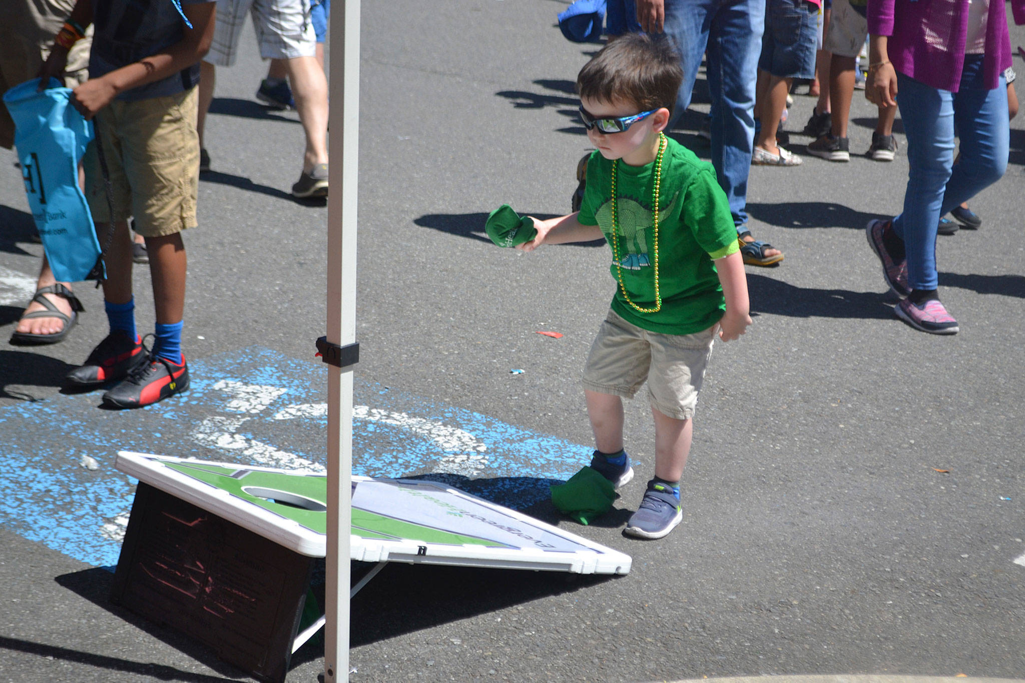 A young resident plays a cornhole game at Derby Days in Redmond. Katie Metzger/staff photo