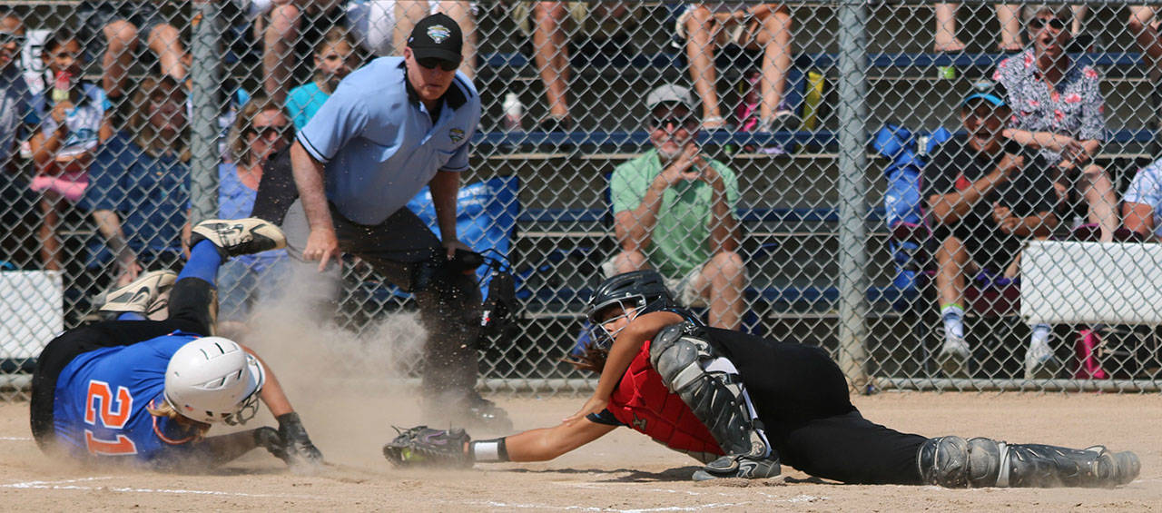 Redmond catcher Kimora Johnson tags out a Central runner. Andy Nystrom / staff photo